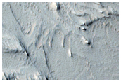 Stratified Material in the Gigas Fossae Region