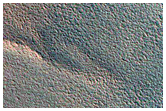 Change Detection of Aprons of Icy Material Draping North Polar Scarp