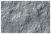 Layered Deposit in Small Craters Northeast of Reull Vallis