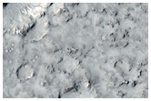 Cratered Cones with Divergent Wakes Near Grjota Valles
