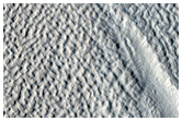 Flow Features and Pits in Crater South of Cerulli Crater
