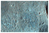 Light-Toned Layered Deposits Within Valleys Southwest of Ladon Valles
