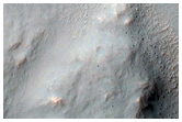 Seven Kilometer Crater with Good Exposures of Layered Bedrock
