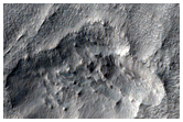 Material Flowing Through Gap in Crater Rim East of Hellas Planitia
