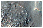 Material Flowing from a Breach in Moanda Crater in Nereidum Montes
