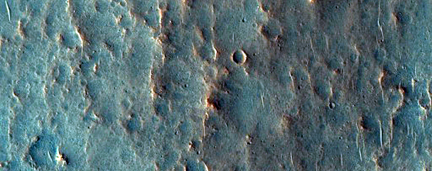 Crater with Light-Toned Spot at Upslope End of Light-Toned Streak
