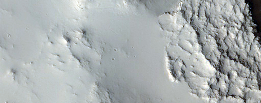 Layered Outcrops in Rim of Crater West of Tikhonravov Crater
