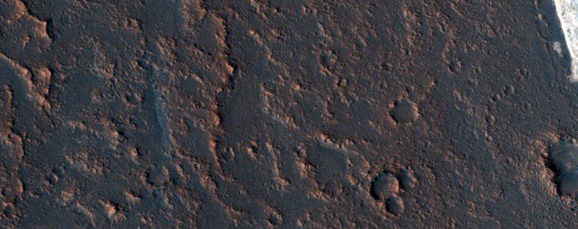 Relatively Bright Layers on Floor of McLaughlin Crater