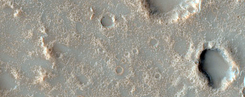 Possible Pitted Impact Melt Pond on the Ejecta of Bakhuysen Crater