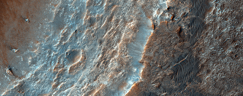 Strata in Crater Wall and Striated Surface at Crater Rim