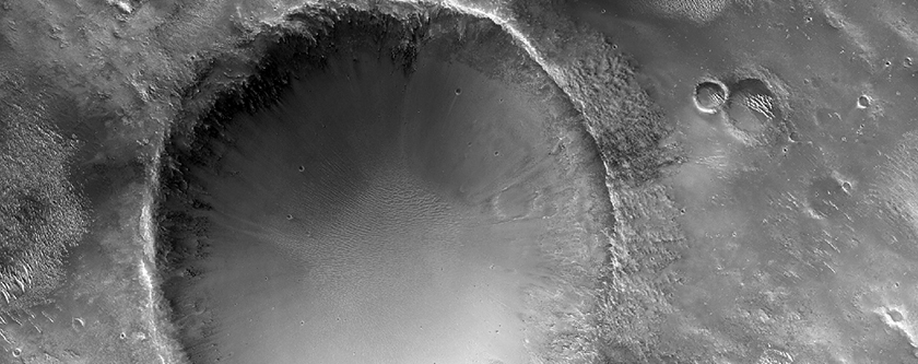 Small Crater Exposing Mineralogy on Northwest Rim of Knobel Crater