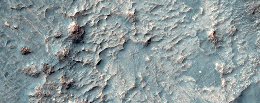 Pit on Crater Floor Exposing Bedrock Layers