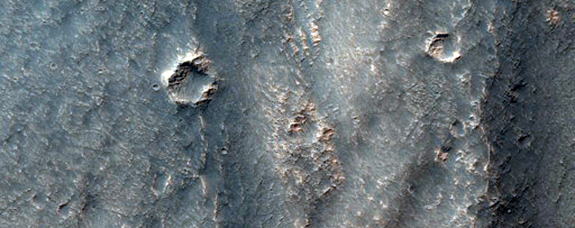 Fossae Crossing a Degraded Crater in Thaumasia Region Highlands