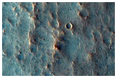 Crater with Light-Toned Spot at Upslope End of Light-Toned Streak

