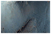 Bedrock Exposed in 60-Kilometer Crater East of Valles Marineris