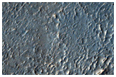Possible Phyllosilicates in Edge of Crater Ejecta Near Mare Serpentis
