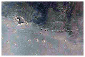 Crater Dissected by Subsidence and Eroded by Ius Chasma Rim