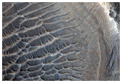 Layers on Wall of Crater Interrupting Channel