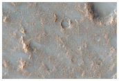 Possible Pitted Impact Melt Pond on the Ejecta of Bakhuysen Crater