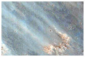 Light-Toned Layered Material Exposed in Coprates Chasma Scarp Wall