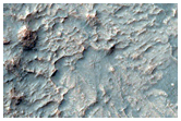 Pit on Crater Floor Exposing Bedrock Layers