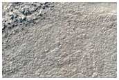 Interaction Ridges and Banded Terrain in Hellas Planitia