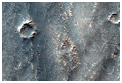Fossae Crossing a Degraded Crater in Thaumasia Region Highlands