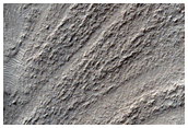 Ridge among Layered Pits and Swirls in Hellas Planitia
