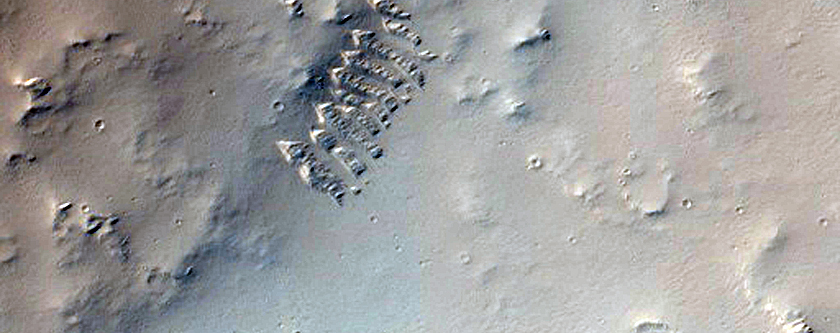 Low Albedo Feature Around Impact Crater