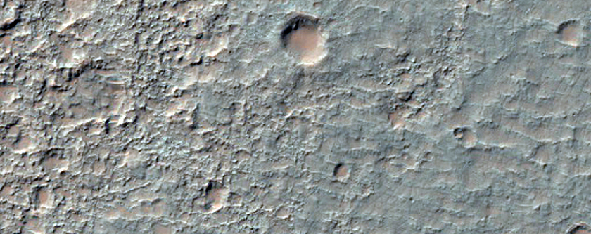 Plains Erosion and Fluidized Ejecta in Tyrrhena Terra