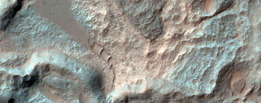 Light-Toned and Swirly Deposits along Floor of Coprates Catena Trough