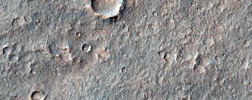 Outflow Channel Features Associated with Small Chaotic Terrain