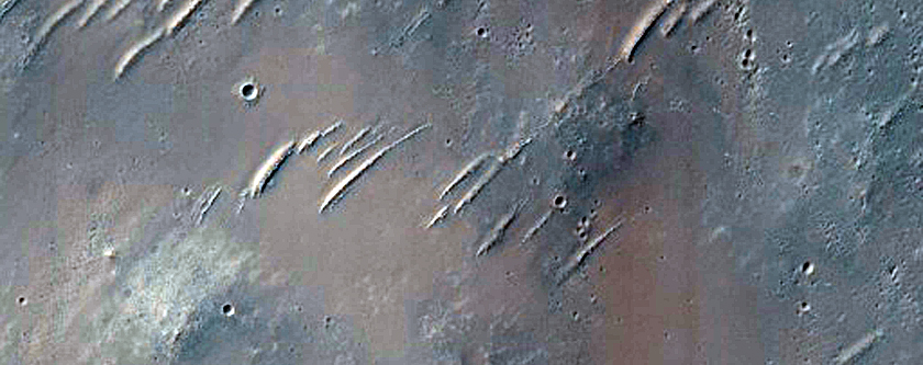 Fresh Small Crater and Steep Rocky Wall of Another