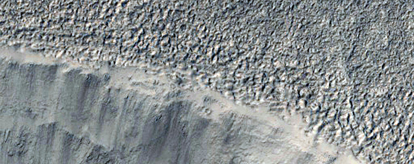 Evidence of Ice and Rock in Crater Near Side Channel of Mamers Valles