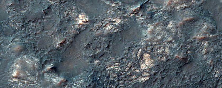 Exposed Crater-Fill Megabreccias and Pitted Materials
