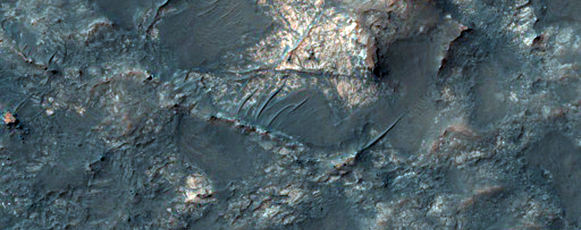 Exposed Crater-Fill Megabreccias and Pitted Materials