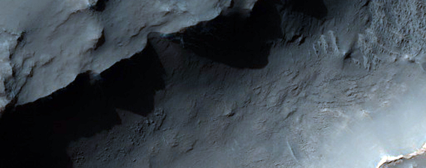 Layers Exposed in Pit on Floor of Roemer Crater