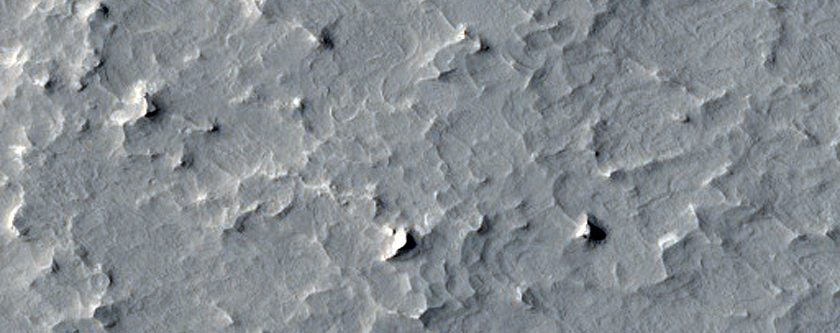 Sinuous Ridges and Impact Ejecta