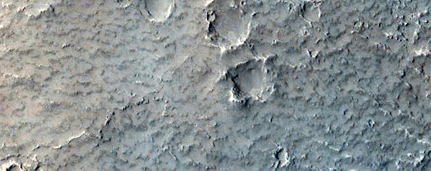Sinuous Ridge Materials Downslope from Fan in Reuyl Crater