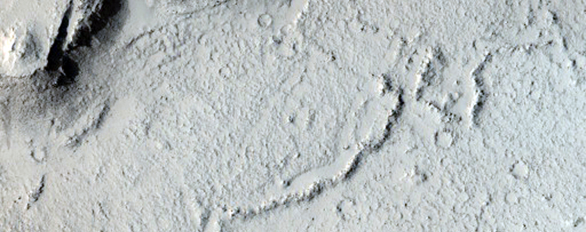Layered Rocks and Scarp on Crater Floor