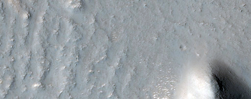 Graben and Impact Crater Intersecting Smooth Terrain