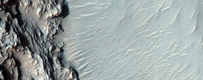 Layered Material Exposed in Pit on Crater Floor