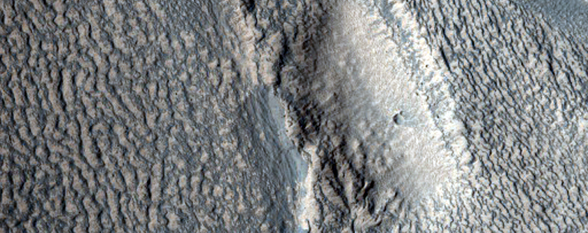 Tongue-Shaped Landform in Contact with Raised Crater Rim