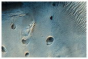 A Dark-Toned, Pitted Mound in a Crater in Northeast Arabia Terra