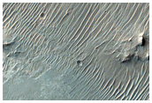 Crater with Light and Dark Layers Exposed in Walls