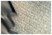 Polar Dunes and Grooved Terrain Changes