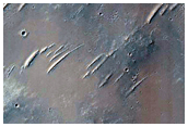 Fresh Small Crater and Steep Rocky Wall of Another