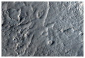 Channel Feeding Possible Lacustrine Deposit in Degraded Crater