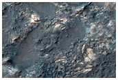 Exposed Crater-Fill Megabreccias and Pitted Materials
