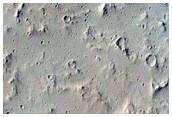 Lava Flow and Impact Crater East of Tharsis Tholus